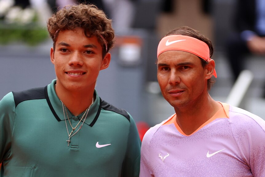 Tennis players Darwin Blanch and Rafael Nadal pose for a photo together at the net before their match at the Madrid Open.
