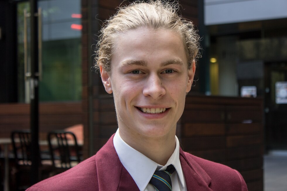 A teenage boy in school uniform