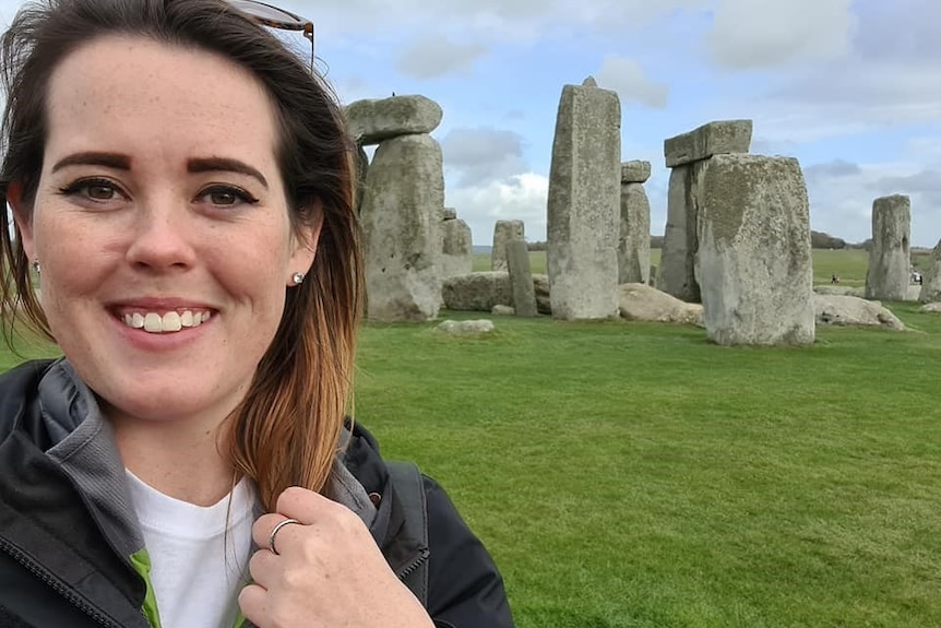 Louise Faint poses for a selfie photo in front of Stonehenge.