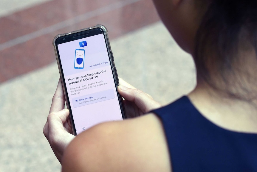 A woman looks at a smartphone app.