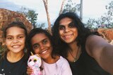 Woman and two of her younger cousins in WA in a story about Indigenous people going back on country during coronavirus.