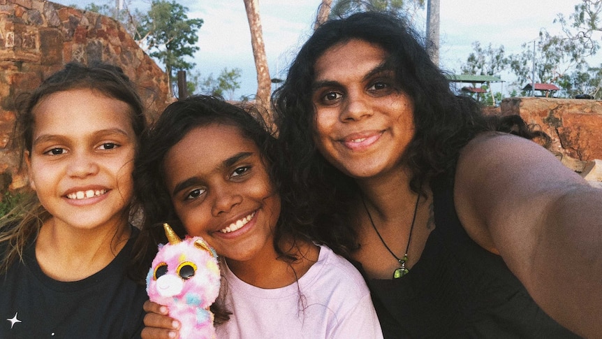 Woman and two of her younger cousins in WA in a story about Indigenous people going back on country during coronavirus.