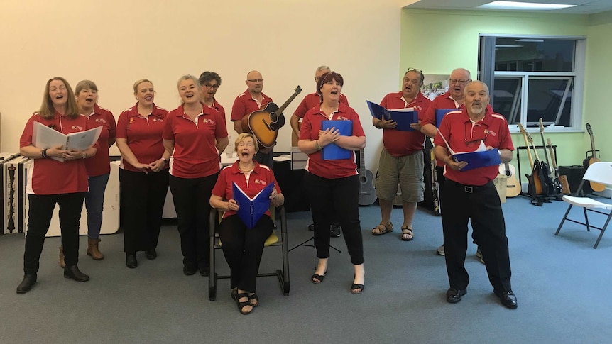 Group of singers from Boots 'n All choir rehearsing in a room in Canberra in 2019.