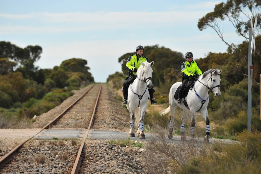 Police on horseback in the SA Murray Mallee search for murder clues