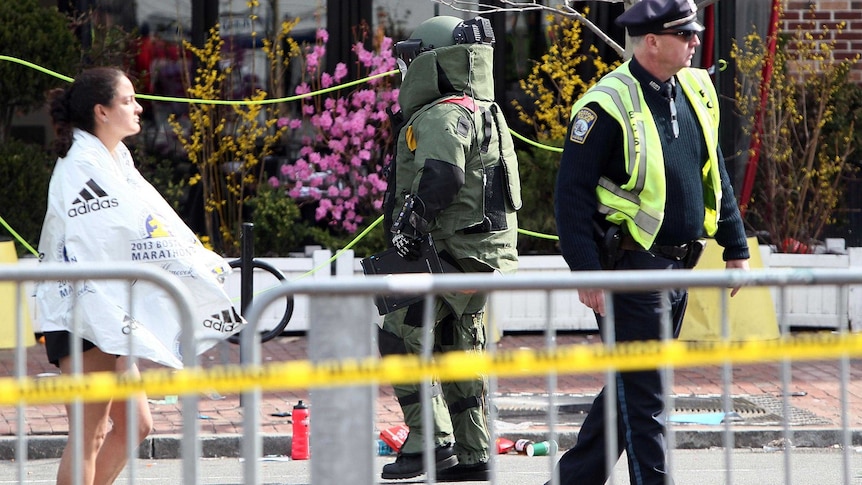 A member of the bomb squad investigates a suspicious item.