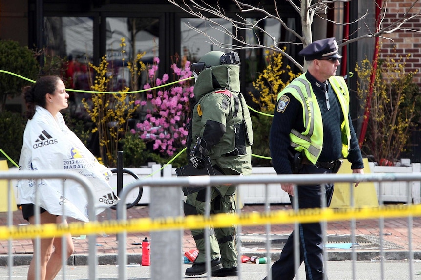 A member of the bomb squad investigates a suspicious item.