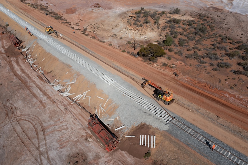 An aerial view of the massive clean-up operation at the site of a remote train derailment.   