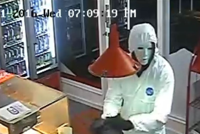 Man in white suit during a robbery at a Cambridge store