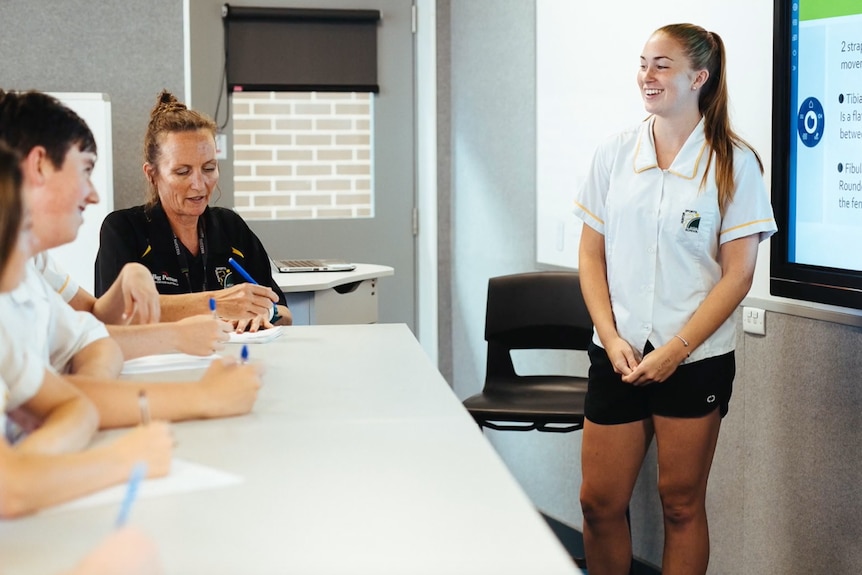 A woman in a classroom environment