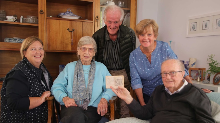 Oliver J Illingworth's family pose for a photo while one of them holds the diary.