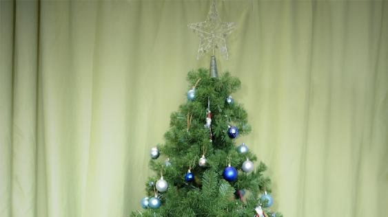 Separated twins Krishna (left) and Trishna play with toys underneath a Christmas tree