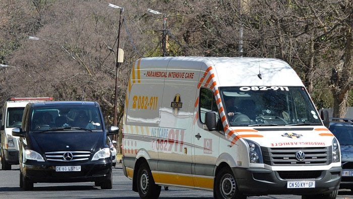 Ambulance carrying Nelson Mandela arrives at his home, September 2, 2013