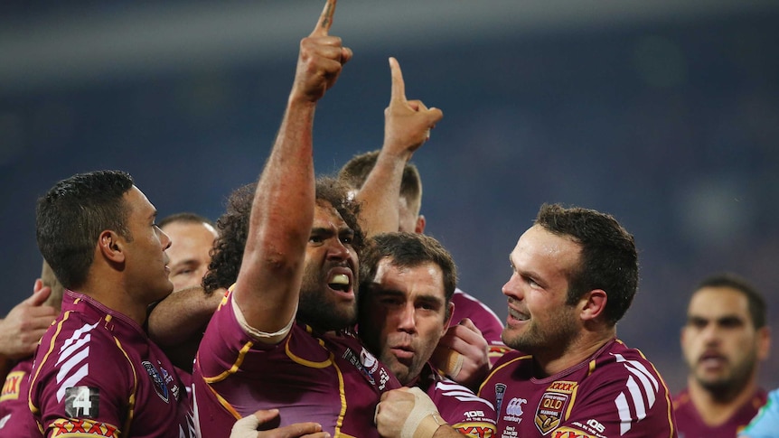 Sam Thaiday celebrates after scoring the opening try.