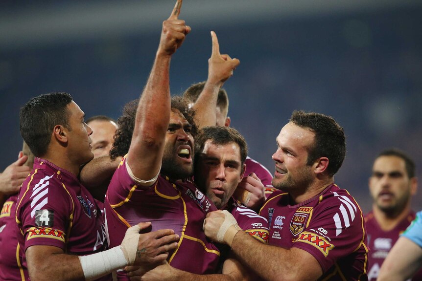 Sam Thaiday celebrates after scoring the opening try.
