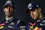 Less than impressed ... Mark Webber (L) sits alongside Sebastian Vettel at the post-race media conference in Kuala Lumpur