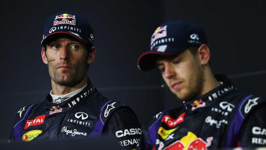 Less than impressed ... Mark Webber (L) sits alongside Sebastian Vettel at the post-race media conference in Kuala Lumpur