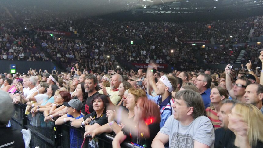 Crowd at the Sydney Entertainment Centre watch Cold Chisel perform.