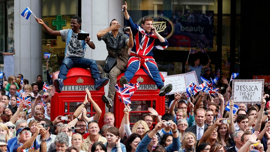 Spectators watch the parade celebrating Britain's Olympic and Paralympic athletes.