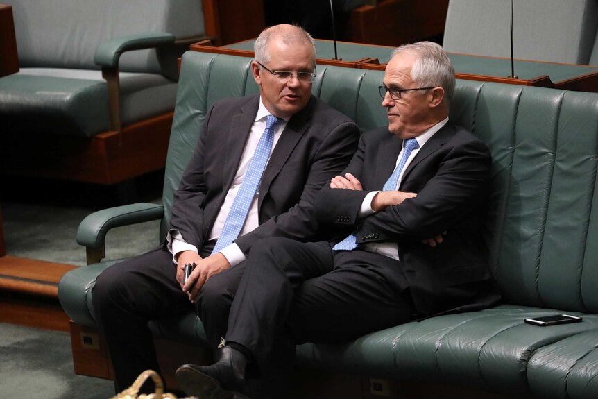 Malcolm Turnbull sits with his harms crossed listening to Scott Morrison in the House of Representatives
