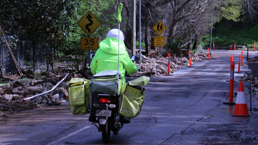 Postman does his rounds in the flood affected Adelaide Hills.