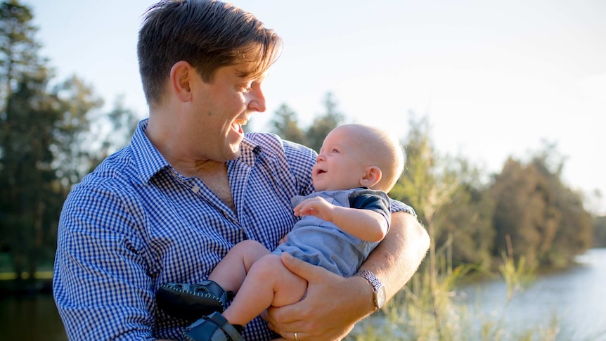 Blake Woodward with child for a story about dad's taking parental leave