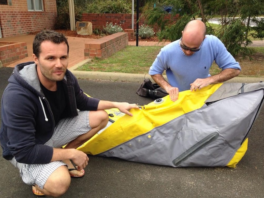 The men show off the bite marks on their inflatable kayak in Dunsborough.