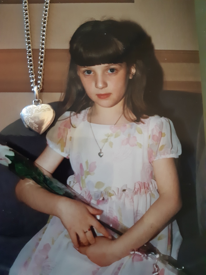 a picture of a young girl with a locket