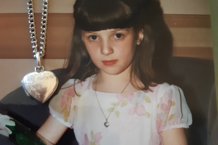 a picture of a young girl with a locket