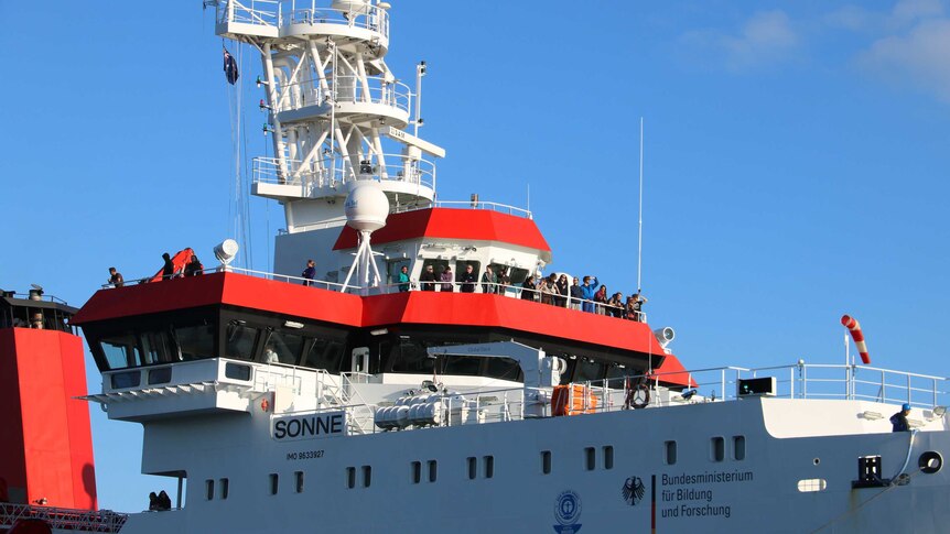 Passengers stand on the top deck of the RV Sonne as the German deep sea research vessel comes into port in Fremantle.