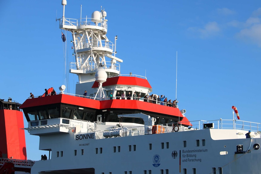 Passengers stand on the top deck of the RV Sonne as the German deep sea research vessel comes into port in Fremantle.