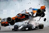 A shattered F1 car flies over the top of another car.