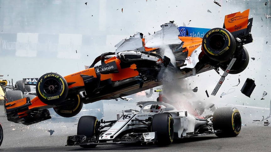 Fernando Alonso's McLaren flies over Charles Leclerc's Sauber