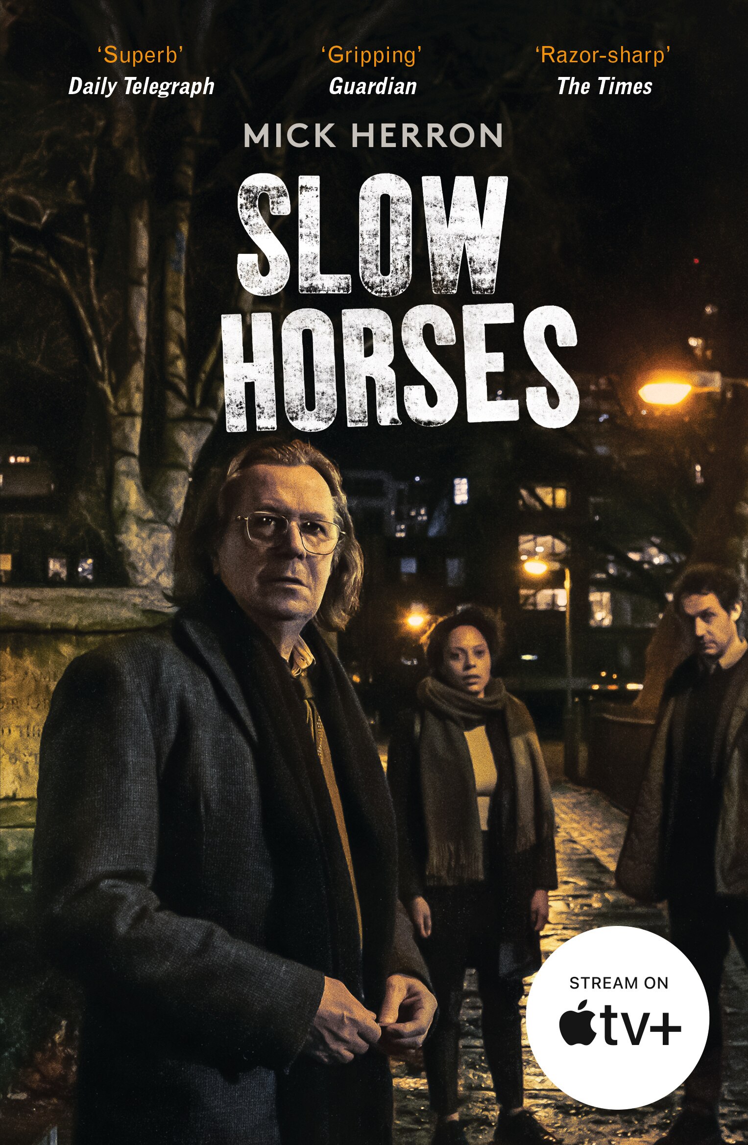 The book cover for Slow Horses by Mick Herron shows three people standing in a dark street, gazing toward the reader.