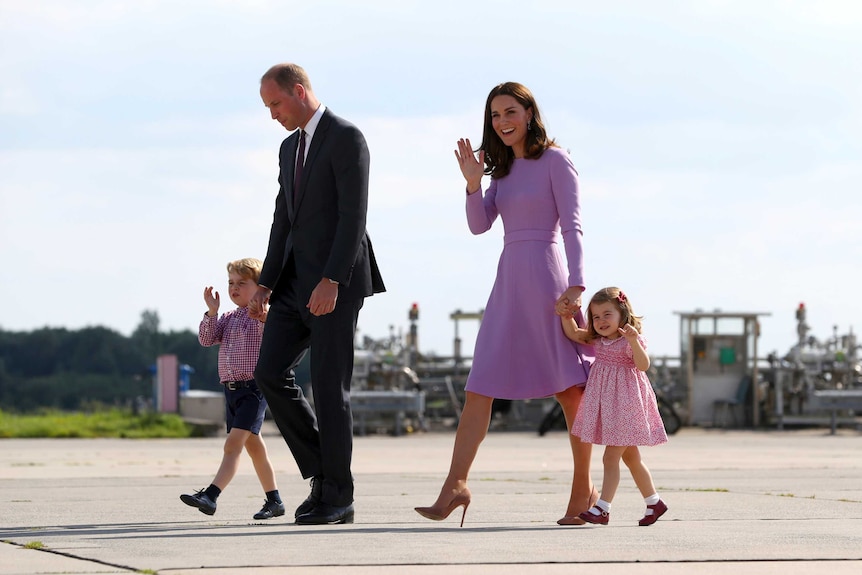 Prince William and the Duchess of Cambridge walk across the tarmac with their children.