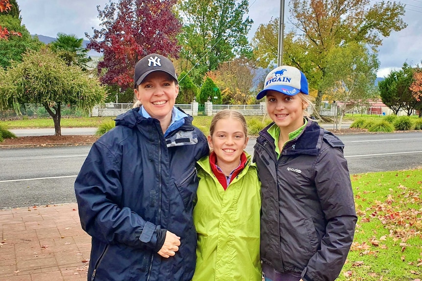 A family of three wearing their new winter jackets.