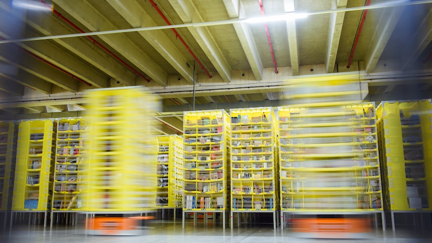 blurry image of inside an Amazon fufillment centre