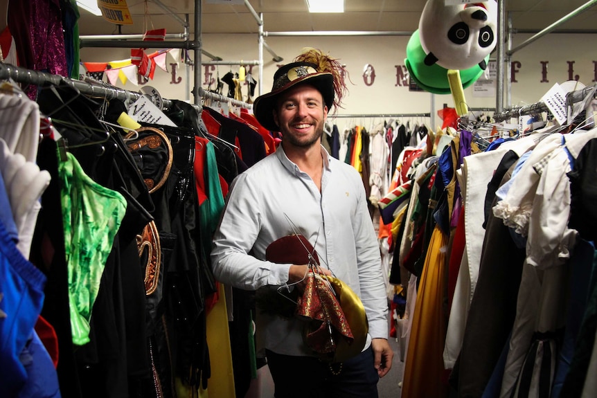 Costumer Ben standing with a fancy hat on.