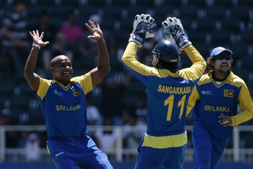 A bowler raises his hands to high-five a wicketkeeper after taking a wicket in an ODI match.