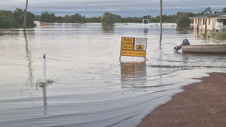 A flooded road in an outback town.