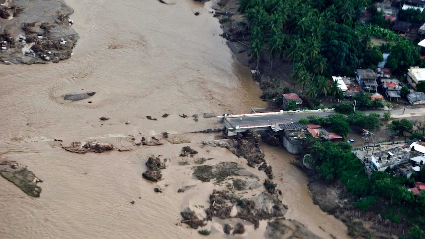Floodwaters wash away a bridge over the Papagayo River.