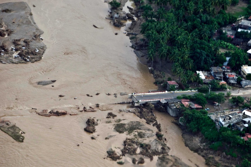 Floodwaters wash away a bridge over the Papagayo River.