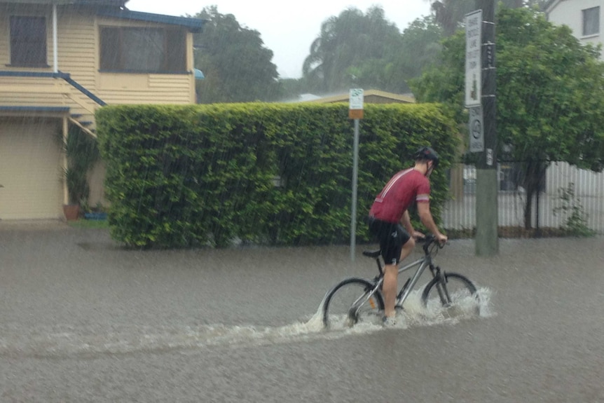 A cyclist makes his way home through rising floodwaters in Windsor.