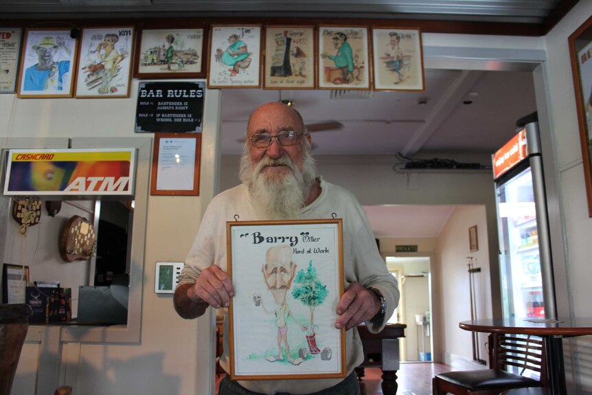 Beechwood Hotel patron Barry holding caricature.