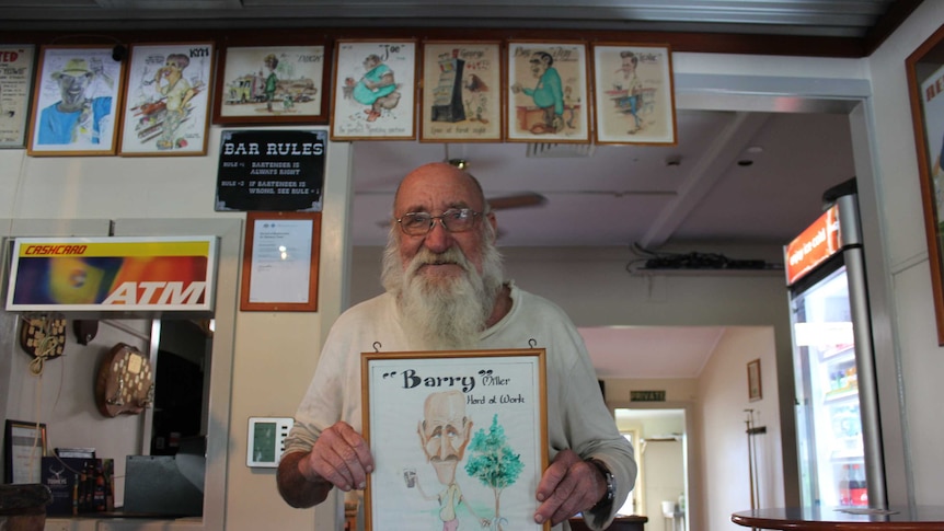 Beechwood Hotel patron Barry holding caricature.
