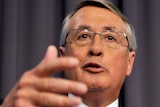 Treasurer Wayne Swan speaks about the mid-year economic forecast during a press conference.