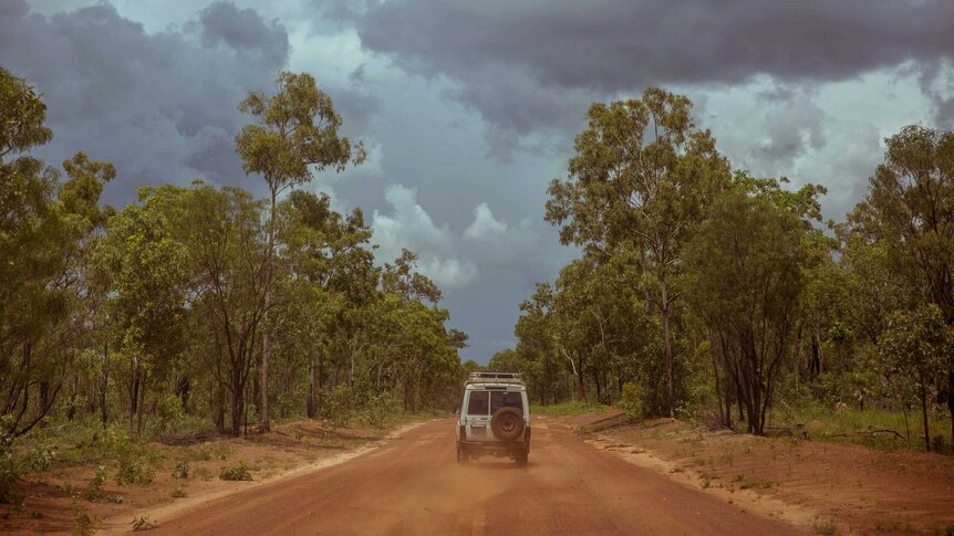 Troop carrier flicks up red dust on the way to Coopers Creek