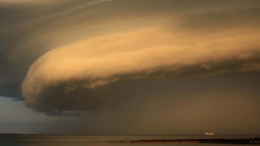 A storm front moves across Darwin Harbour at around 7pm.