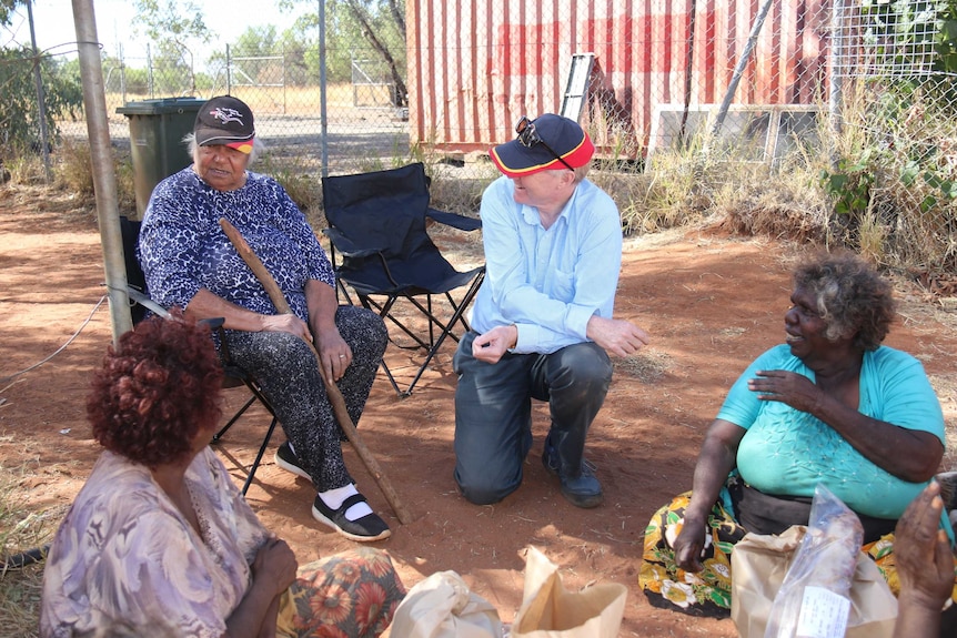 Rosalie Kunoth Monks and Phillip Heath sit with local women in Utopia