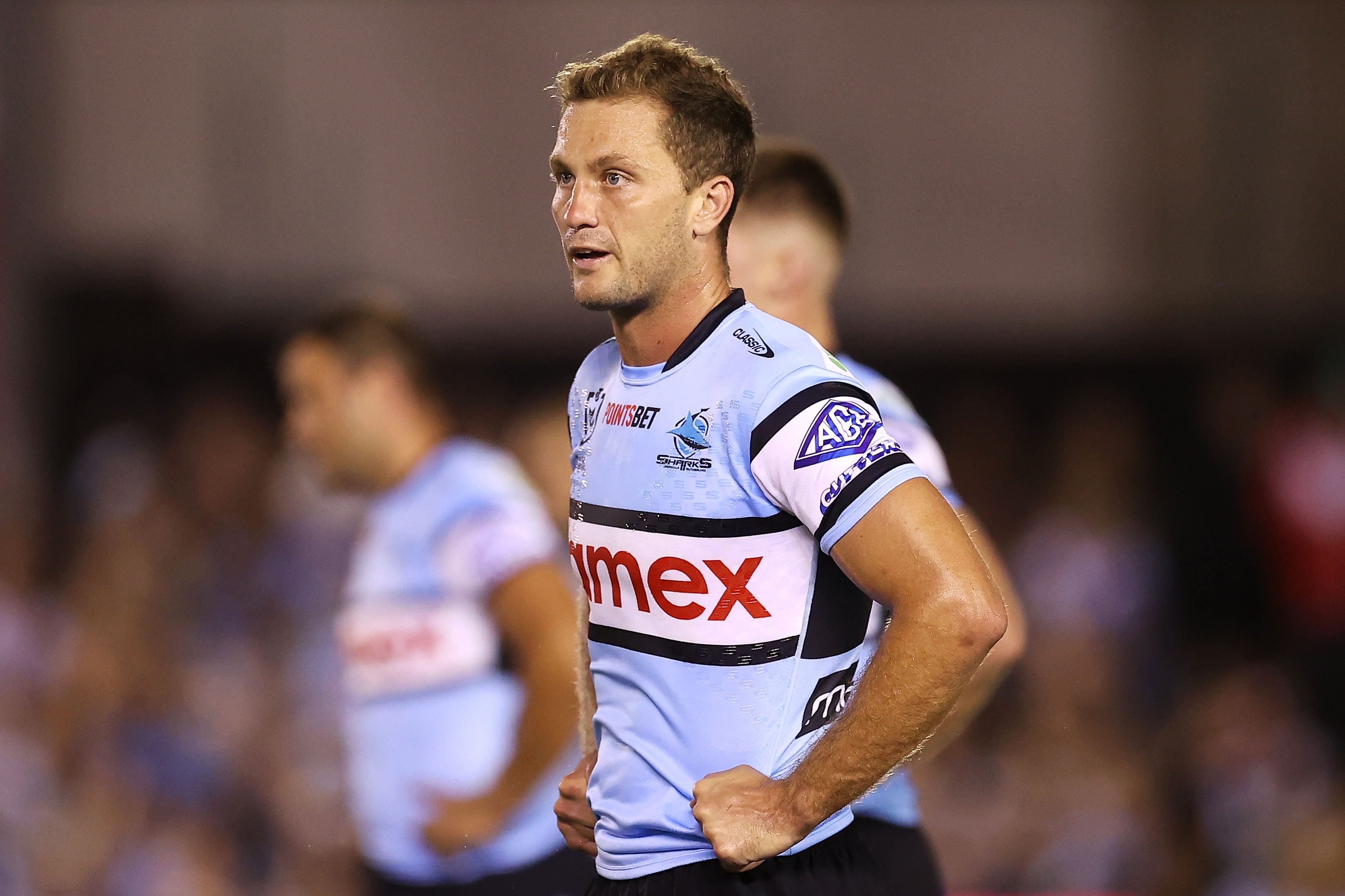 A man looks on after his rugby league team concedes a try 