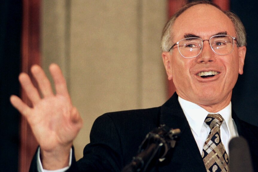 John Howard smiles during a 1996 press conference. 